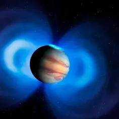 Największa planeta układu słonecznego, Jowisz, otoczona jest przez niebieskie pole magnetyczne i zorze polarne.
