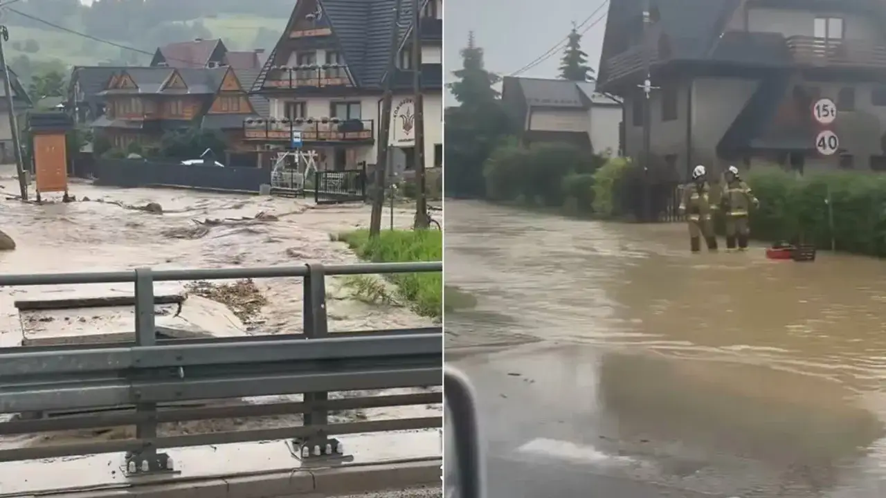 Po powodzi w górskiej miejscowości, strażacy w wodzie sprawdzają zniszczenia. Domy i ulice są zalane.